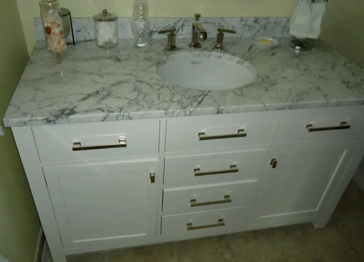 White shaker bathroom vanity with a marble top, undermount sink and brushed nickel pulls, the style of vanity built for Santa Maria CA bathrooms