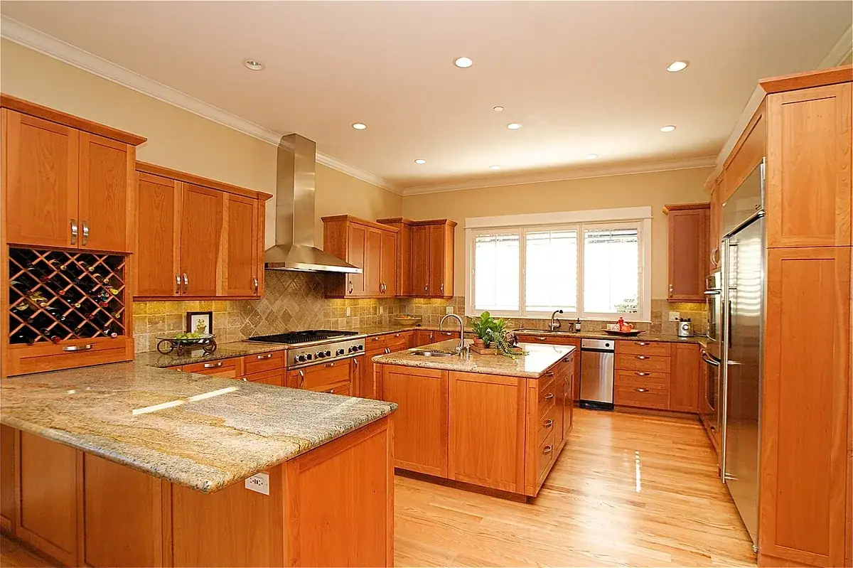 Custom cherry kitchen cabinets with granite counters and a built in wine rack in a California home