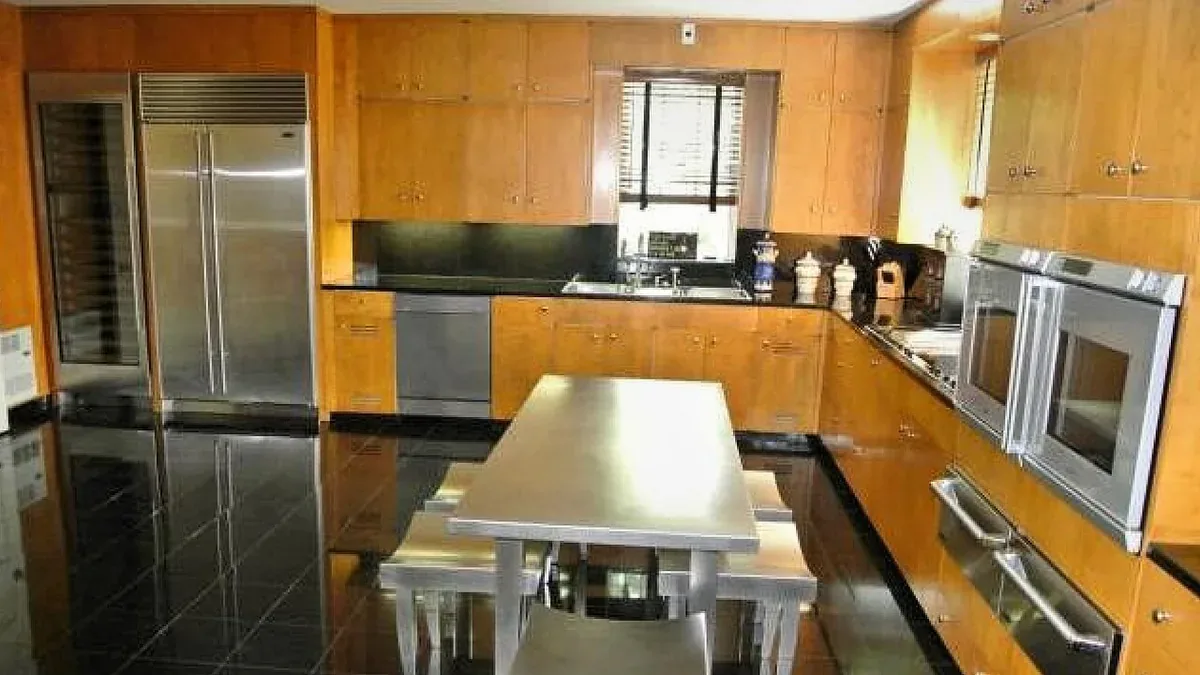 Kitchen with warm slab front wood cabinets, black granite counters and stainless appliances, the scale of kitchen cabinet work done in Santa Maria CA