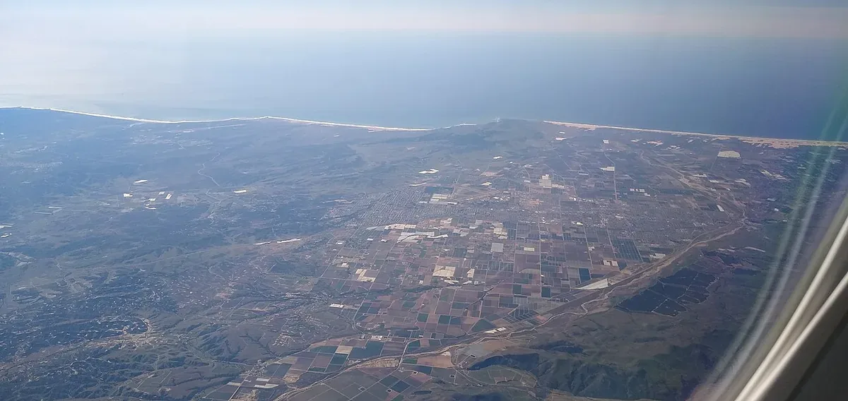 Aerial view over the Santa Maria Valley in CA showing the city, surrounding farmland and the coastline